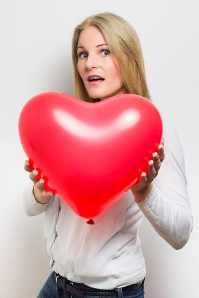 Woman holding a red heard — Stock Photo, Image