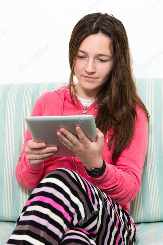 Brunette Teenage Girl Working On A Table PC