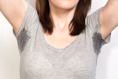 Woman sweating very badly under armpit clipart