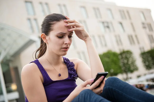 Problems - young woman with phone — Stock Photo, Image