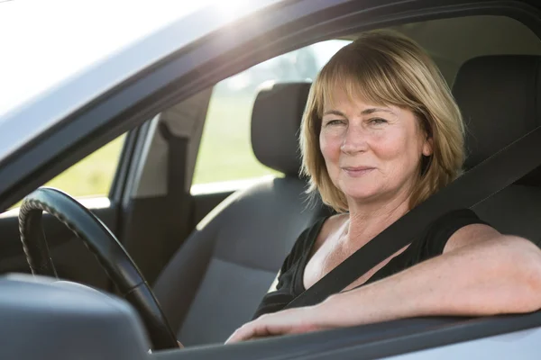 Portrait of senior woman in car — Stock Photo, Image