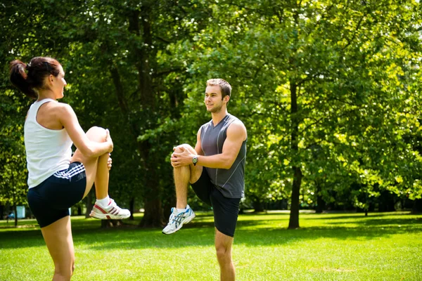 Warm up - couple exercising before jogging — Stock Photo, Image