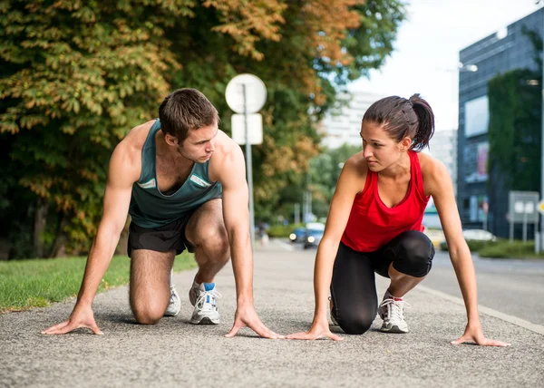 Rivalry - young couple competing in running — Stock Photo © martinan ...