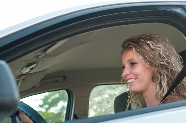 Portrait of young smiling person driving car — Stock Photo, Image