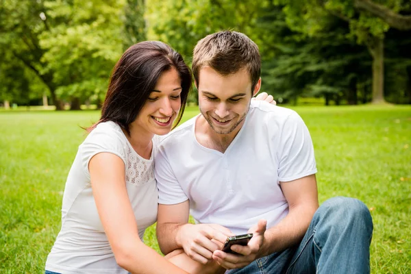 Young couple with smartphone — Stock Photo, Image