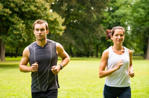 Jogging together - young couple running — Stock Photo, Image