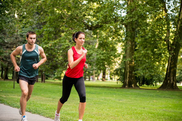 Training together - young couple jogging