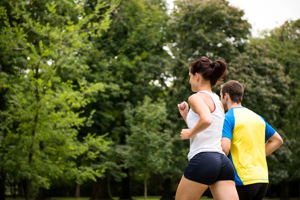 Jogging together - young couple running — Stock Photo, Image