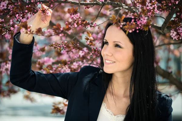 Beauty - woman and Flowering tree — Stock Photo, Image