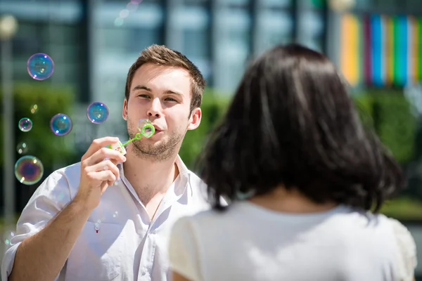 Couple have fun with bubble blower — Stock Photo, Image
