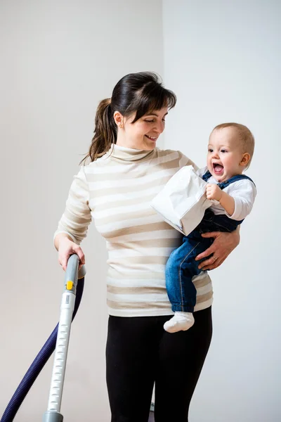 Cleaning home - mother with baby — Stock Photo, Image