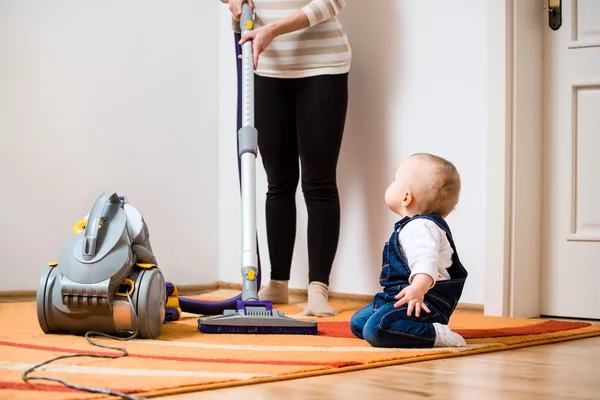 Cleaning home - mother with baby — Stock Photo, Image