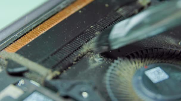 Close up of a master hand touches dust on cooler of the video card with a brush. — Stockvideo