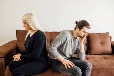 İnatçı karı koca, eşler evdeki koltukta ayrı otururlar. Birbirlerini görmezden gelirler.