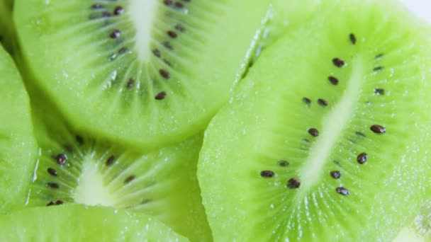 Extrem närbild Färgglada färska kiwi citrus frukt skivor bilder av roterande exotisk frukt på bordet — Stockvideo