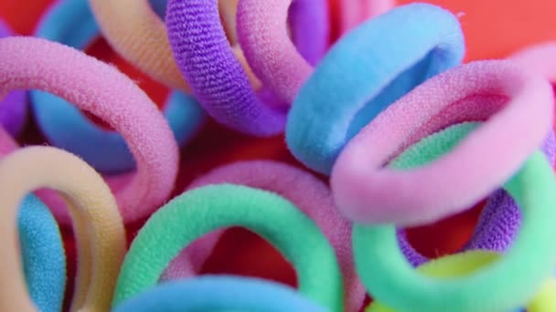 Bovenaanzicht van een levendige kleuren roterende close-up elastiekjes. — Stockvideo