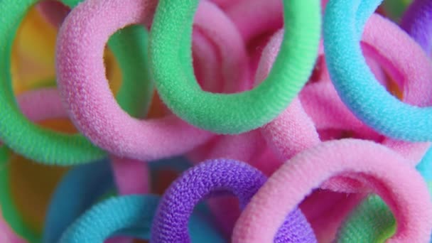 Vivid colors rotating close up textile rubber bands — ストック動画