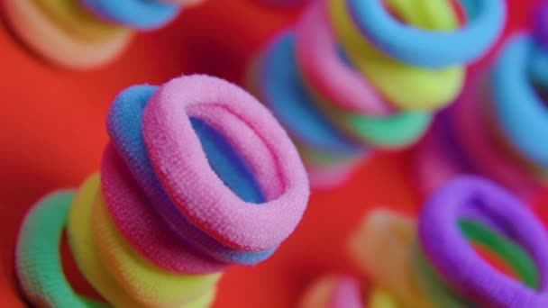 Rotating vibrant close up of a rubber bands on the red background. — Stock Video