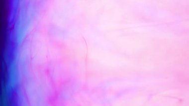 4K footage vivid color ink paint drops in water in slow motion.
