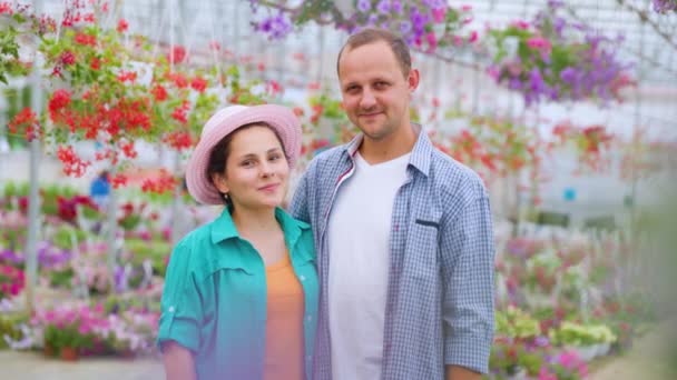 Family Successful Flower Growers Stands Greenhouse Guy Girl Look Each — 图库视频影像