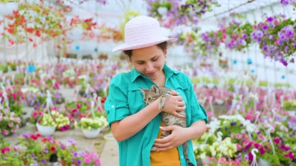 Joyful Young Lady Greenhouse Flowers Holds Gray Kitten Her Hands — Stok video