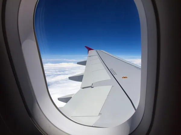 Window of airplane - flight over clouds — Stock Photo, Image