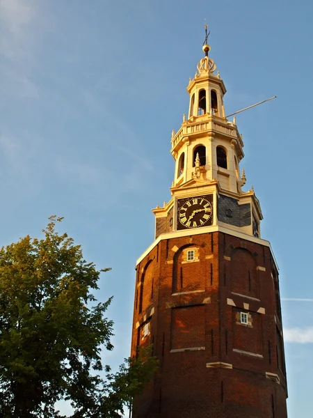 Ancient tower with clock in the historical city center of Amsterdam — Stock Photo, Image