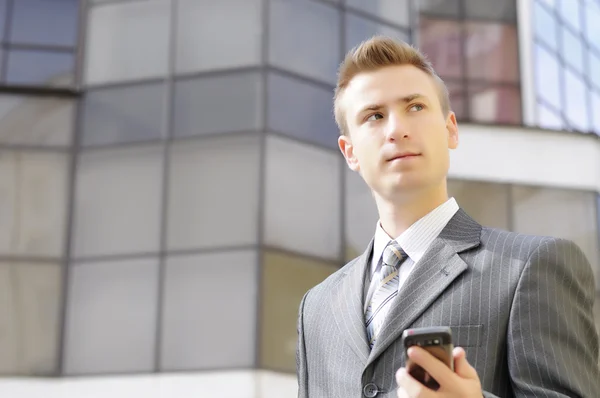 Businessman holds the phone — Stock Photo, Image