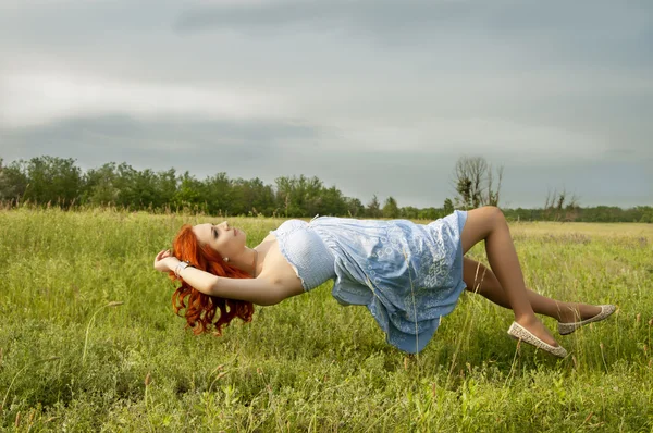 Levitating girl flying above the ground. — Stock Photo, Image