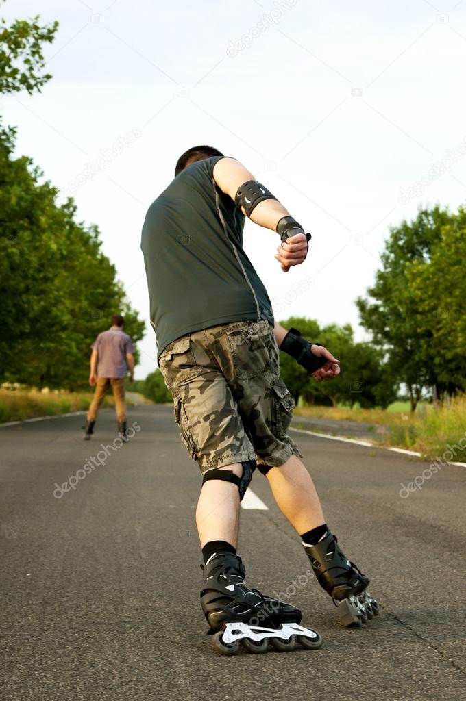 Young man with inline skates in summer