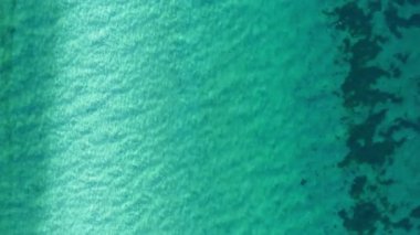 Su yüzeyi dokusu. Hareket temiz dalgalanmalar ve el sallama. Üst görünüm deniz kenarı, güneş ışığı su arka planı. Su arkaplanı