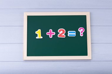 Manyetik numaraları olan okul yönetim kurulu. Örnekler çözülüyor. Çocuklar için Matematik
