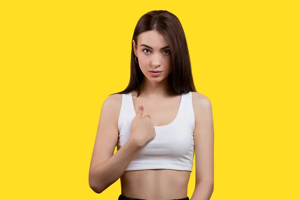 Portrait Cute Girl Pointing Her Finger Herself White Top Yellow — Stock fotografie