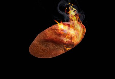 Fresh loaf of bread on fire on a black background