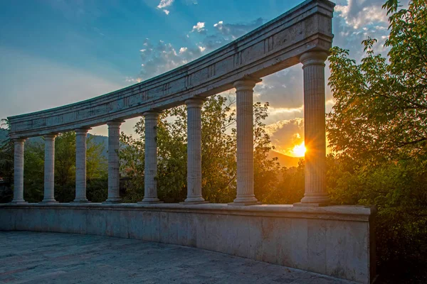 Stone Ancient Colonnade Blue Sky Green Forest Illuminated Sunset Light — Foto Stock