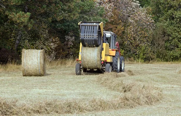 Machine with straw bales, the ball goes out of the press — Stock Photo, Image