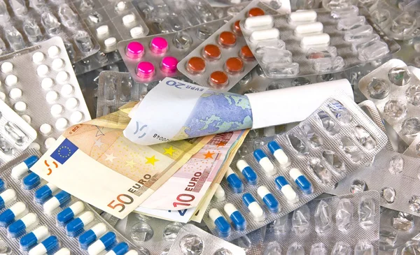 Pengar och medicin, läkemedelsindustrin Royaltyfria Stockfoton