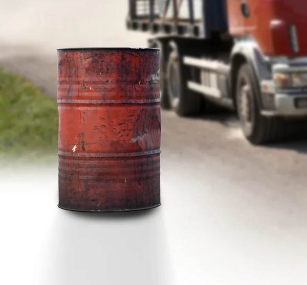 Rusty oil barrel and truck — Stock Photo, Image