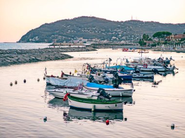 Italy, tourist port of San Bartolomeo with moored boats and landscape of the Ligurian coast