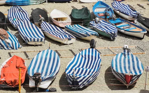 small fishing boats of Liguria with cover and moored in the beach