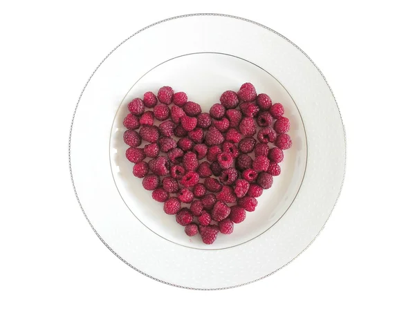 Red raspberries on plate — Stock Photo, Image