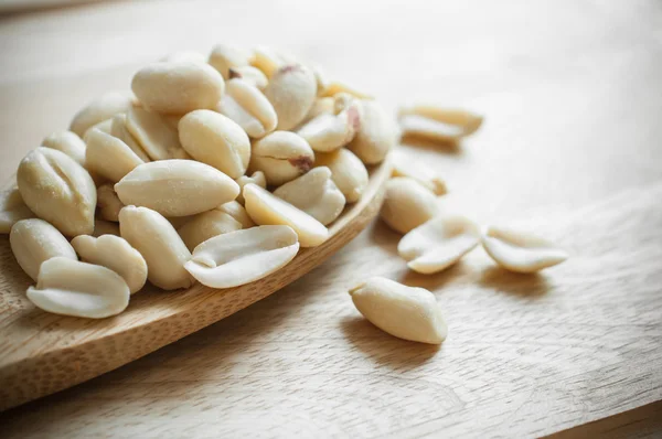 Peanuts closeup on wood ladle — Stock Photo, Image
