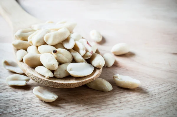 Peanuts on wood ladle closeup — Stock Photo, Image