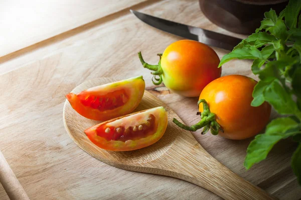 Tomatoes slice on wood ladle closeup — Stock Photo, Image