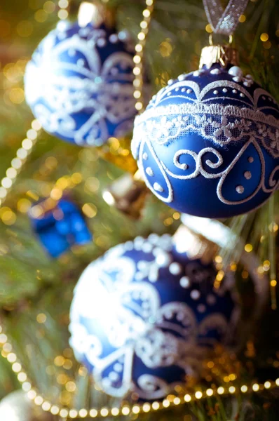 Hermosas decoraciones de Navidad azul colgando en el árbol de Navidad con resplandor brillante —  Fotos de Stock