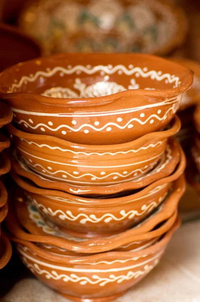 Rustic handmade ceramic clay souvenirs decorated by traditional ornament — Stock Photo, Image