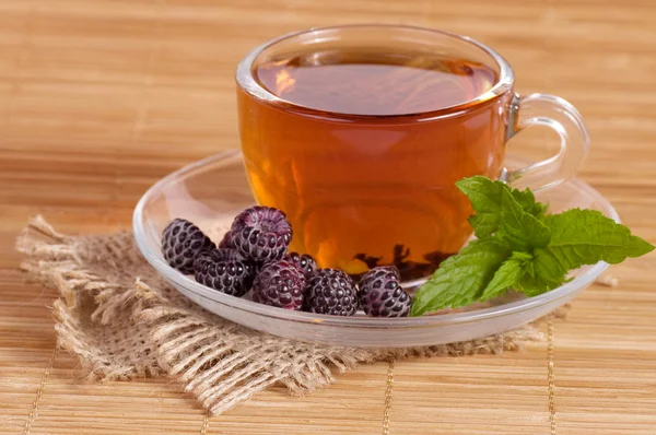 Fruit tea(tea package) in cup with blackberry — Stock Photo, Image