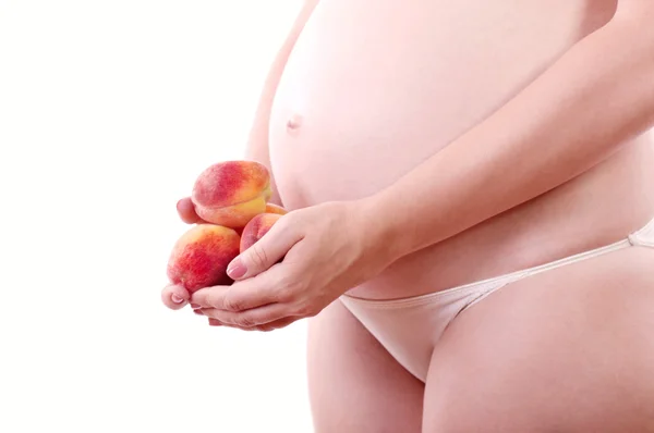 Zwangerschap en voeding - zwangere vrouw met vruchten — Stockfoto