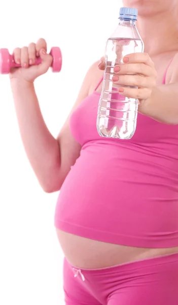 Těhotná žena s vodou a činka — Stock fotografie