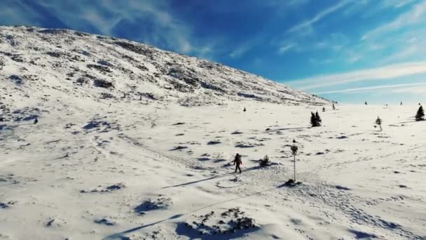 南乌拉尔，高山雪坡的空中景观。游客沿着雪地的小径走到山顶。明亮的蓝天布满了小而明亮的白云.桑尼。徒步旅行 — 图库视频影像